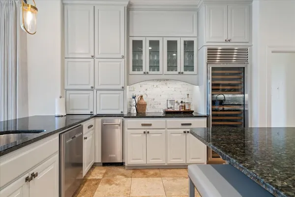 a kitchen with granite countertop a sink and cabinets