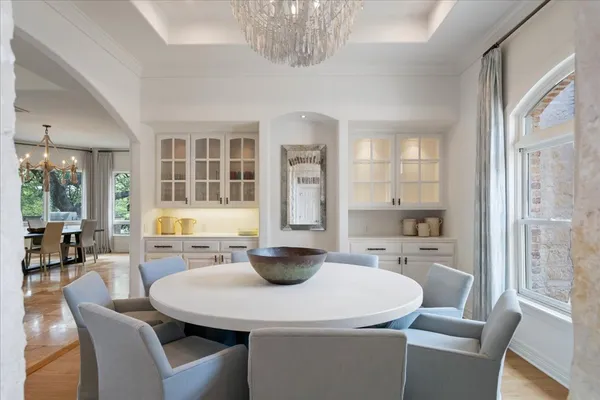 a kitchen with a table chairs and wooden floor