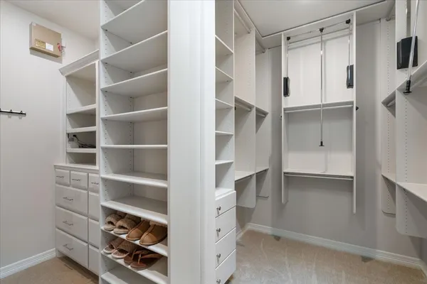 a view of walk in closet with empty racks
