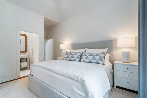 a large white bed in a white room