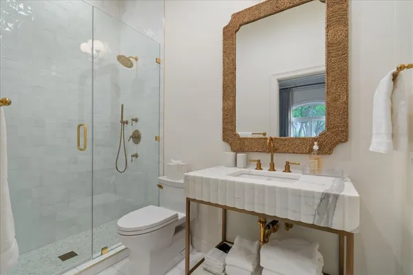a bathroom with a sink toilet and shower