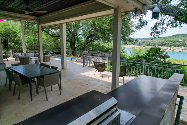 a view of a patio with a table chairs and a backyard
