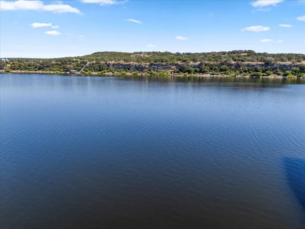 a view of a balcony with lake view and a potted plant