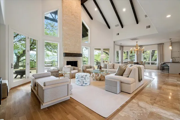 a living room with fireplace furniture and a large window