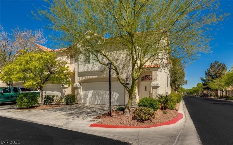 5272 Island Chain Road Las Vegas, NV 89118 - Photo 3 of 31 A Mediterranean-inspired exterior with stucco finish and a classic tile roof creates inviting curb appeal.