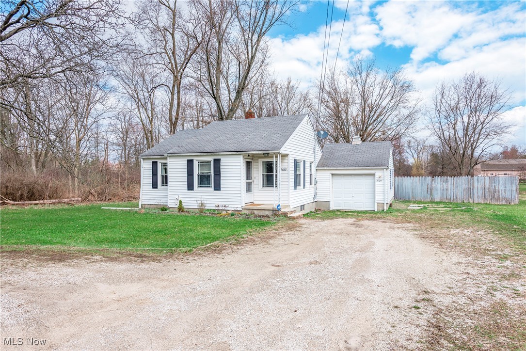 4903 Center Road Brunswick, OH 44212 - Photo 44 of 45 View of front of property with an outbuilding, fence, a front yard, dirt driveway, and a shingled roof