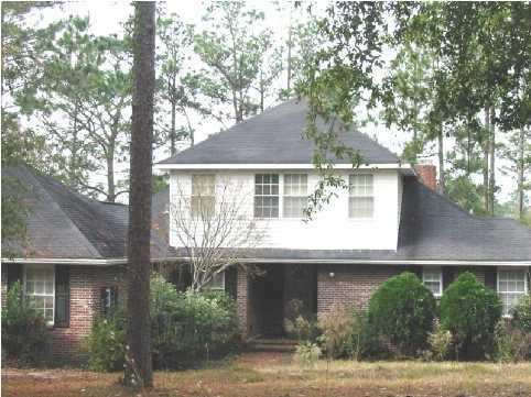 2642 Spring Lake Road DeFuniak Springs, FL 32433 - Photo 1 of 8 a front view of a house with garden