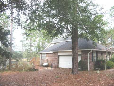 2642 Spring Lake Road DeFuniak Springs, FL 32433 - Photo 3 of 8 a front view of a house with a yard