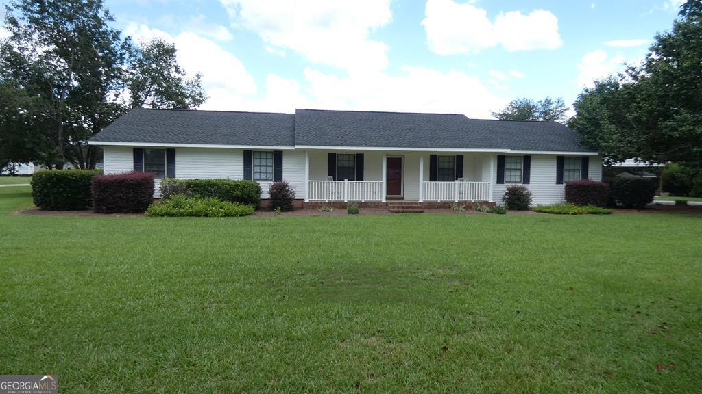 19 Rhett Butler Drive Baxley, GA 31513 - Photo 1 of 1 a front view of a house with a garden and yard