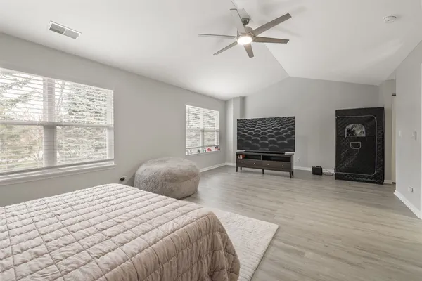 a bedroom with a bed and a large window