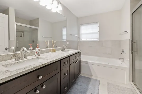 a bathroom with a granite countertop sink a toilet and bathtub