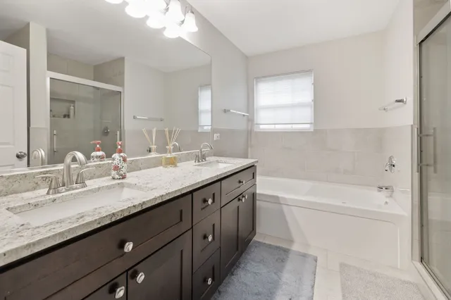 a bathroom with a granite countertop sink a toilet and bathtub