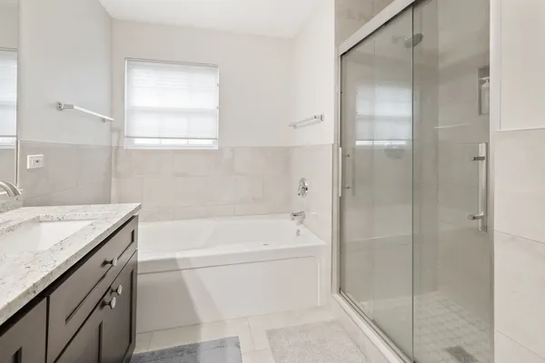 a bathroom with a granite countertop sink a toilet and shower