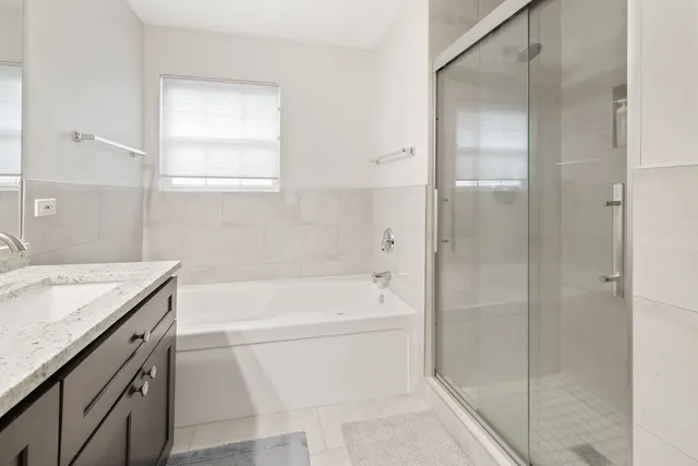 a bathroom with a granite countertop sink a toilet and shower