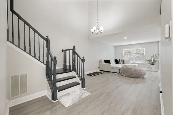 a living room with furniture and a chandelier