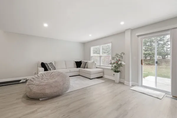 a bedroom with furniture and a large window