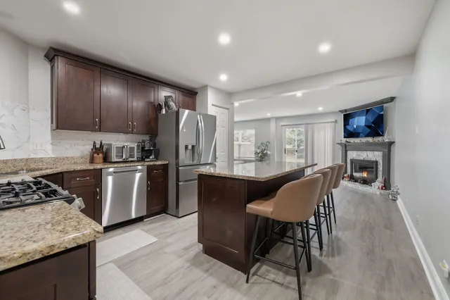a kitchen with a table chairs refrigerator and cabinets