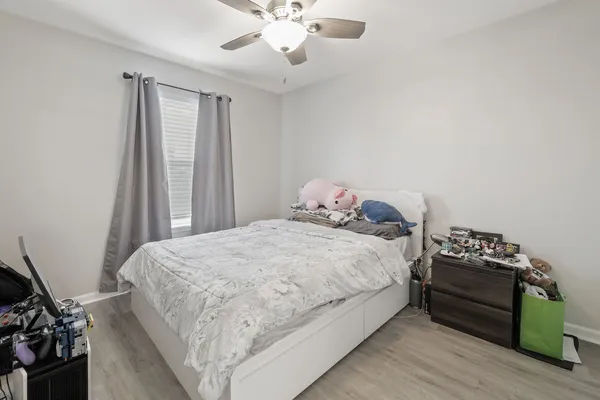 a bedroom with a bed and a chandelier
