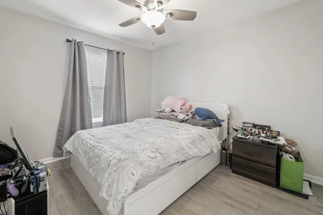 a bedroom with a bed and a chandelier
