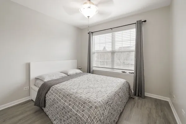 a bedroom with a bed and a window