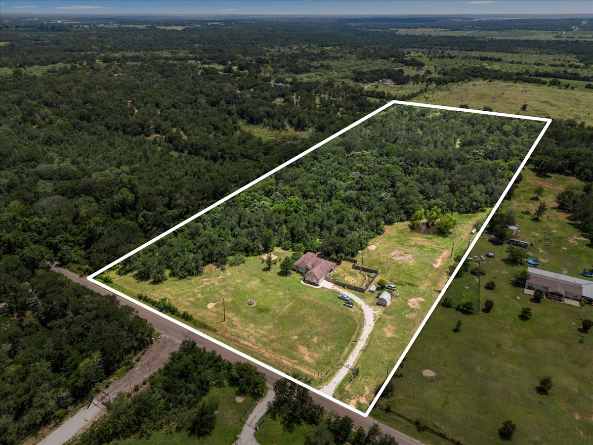 437 Balch Road Elgin, TX 78621 - Photo 32 of 37 Boundary Lines Approximate An aerial perspective reveals a secluded estate nestled within a verdant, expansive acreage.