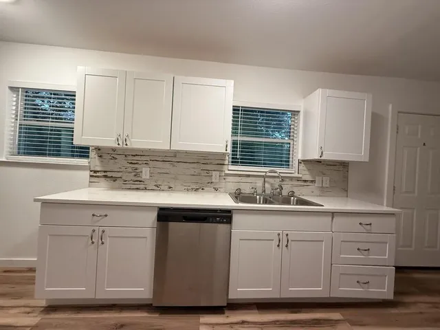 a kitchen with cabinets appliances and a sink
