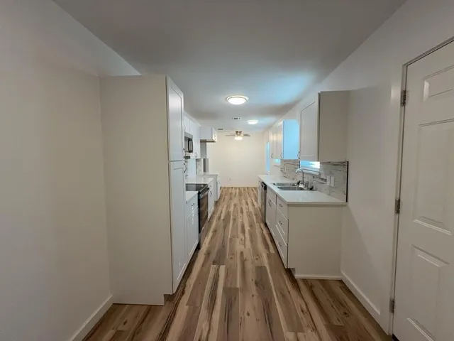 a view of hallway with wooden floor