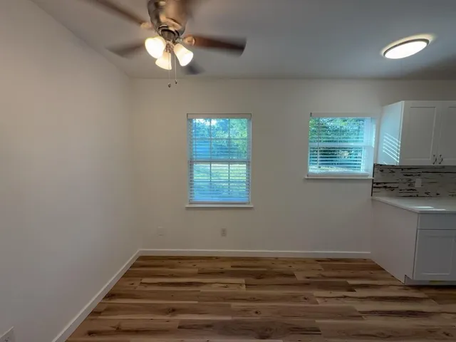 a view of a livingroom with a ceiling fan and window