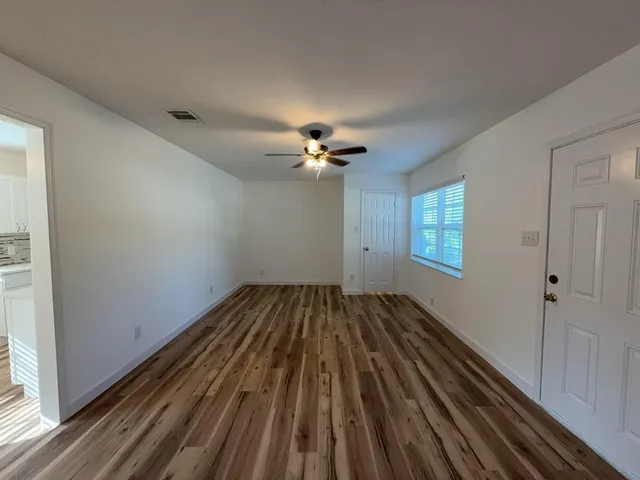 a view of an empty room and wooden floor