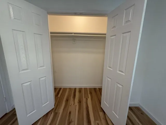 a view of a room with wooden floor and a sink