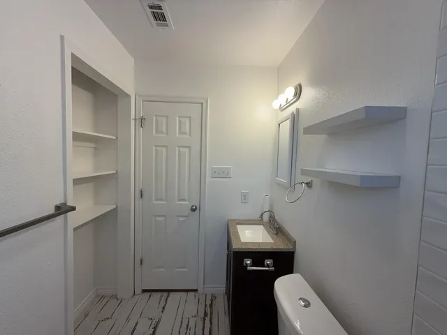a bathroom with a toilet sink and shower