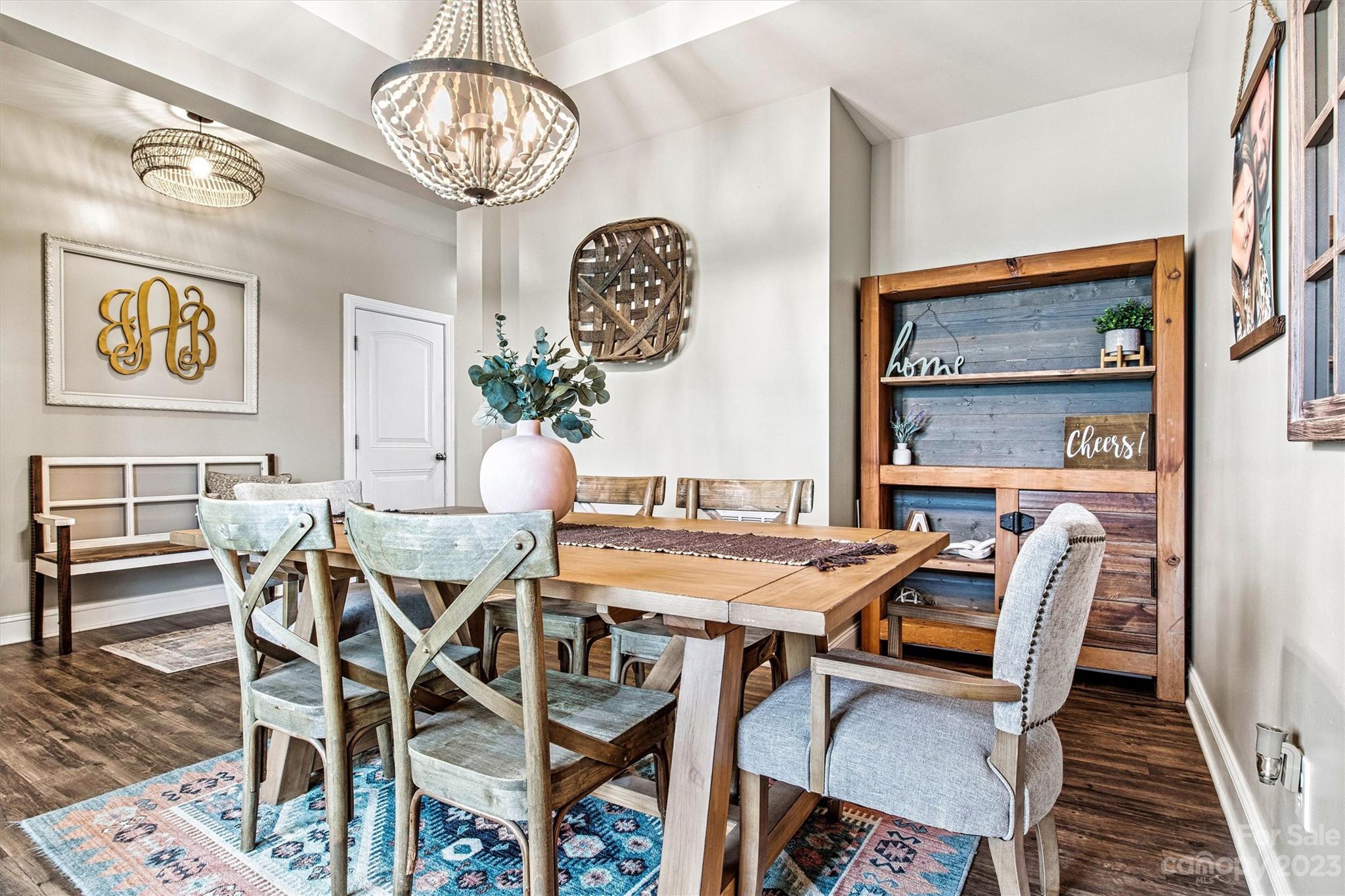 6054 Durango Way Denver, NC 28037 - Photo 14 of 38 a view of a dining room with furniture a chandelier and wooden floor
