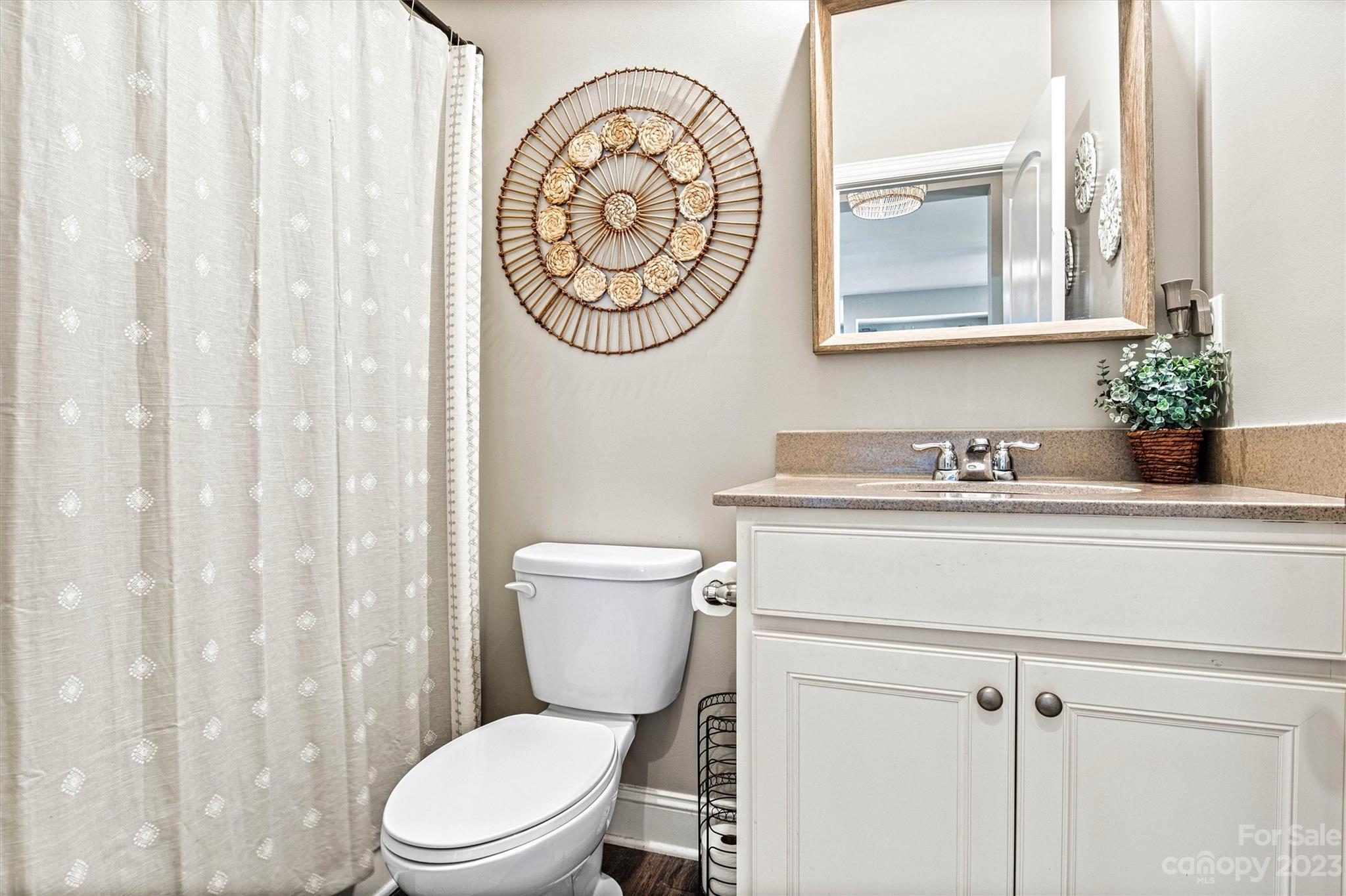 6054 Durango Way Denver, NC 28037 - Photo 17 of 38 a bathroom with a toilet sink and mirror