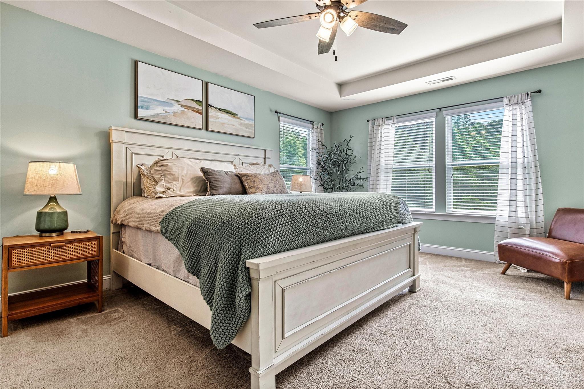 6054 Durango Way Denver, NC 28037 - Photo 19 of 38 a bedroom with a bed and a chandelier