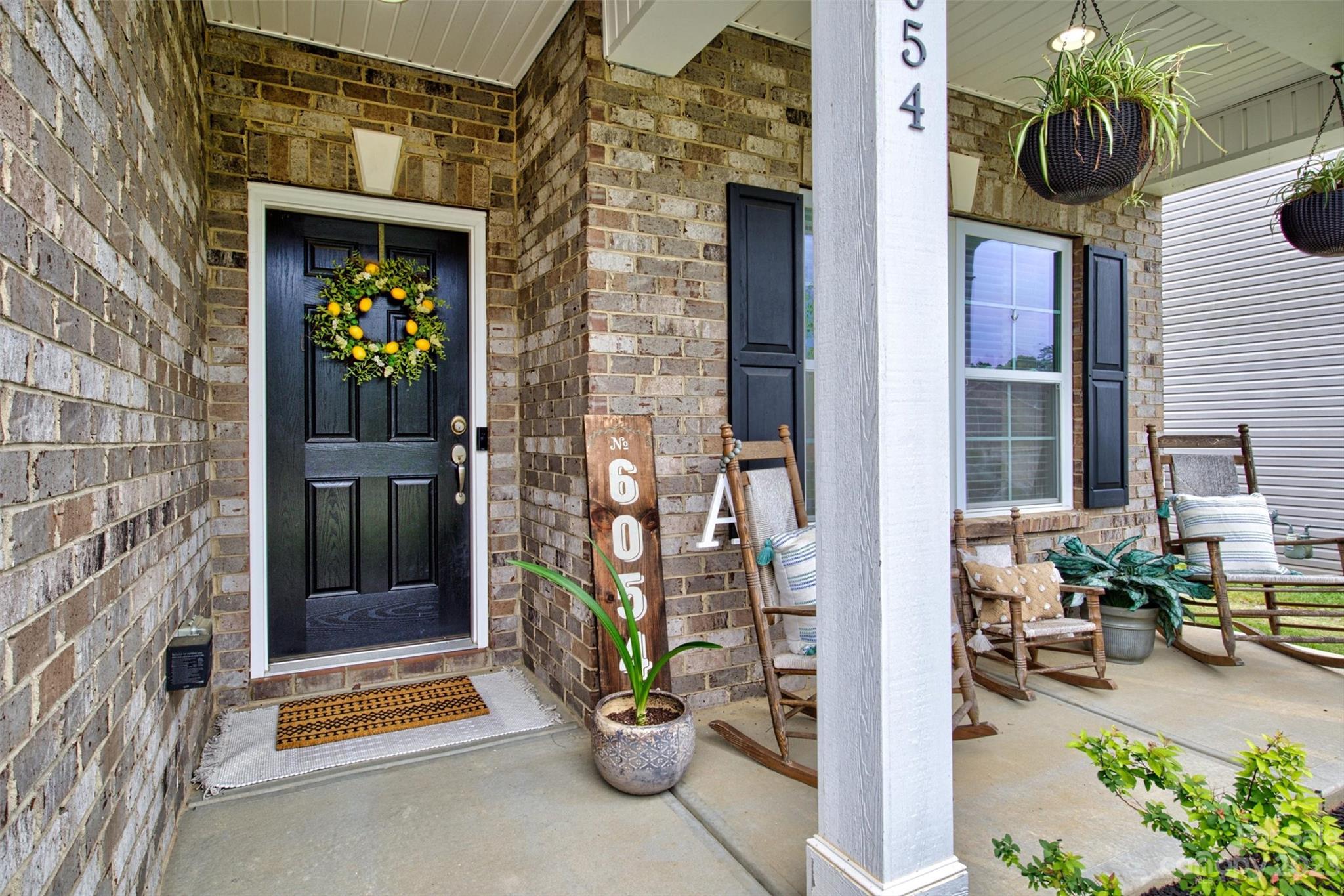 6054 Durango Way Denver, NC 28037 - Photo 2 of 38 a front view of a house with a garden