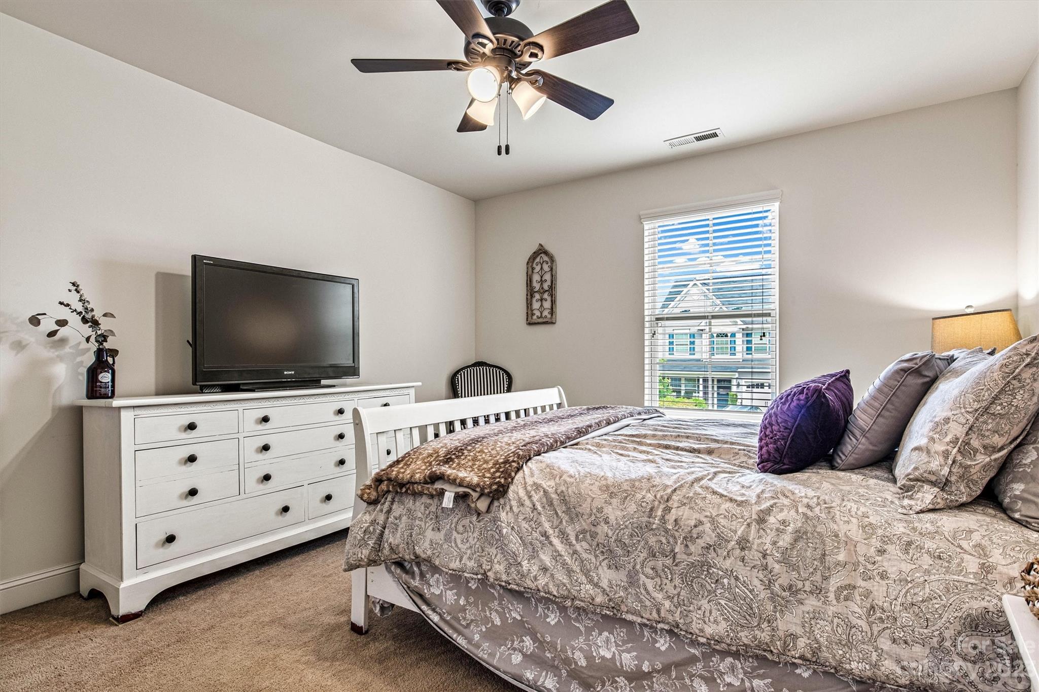 6054 Durango Way Denver, NC 28037 - Photo 27 of 38 a bedroom with a bed and a flat screen tv