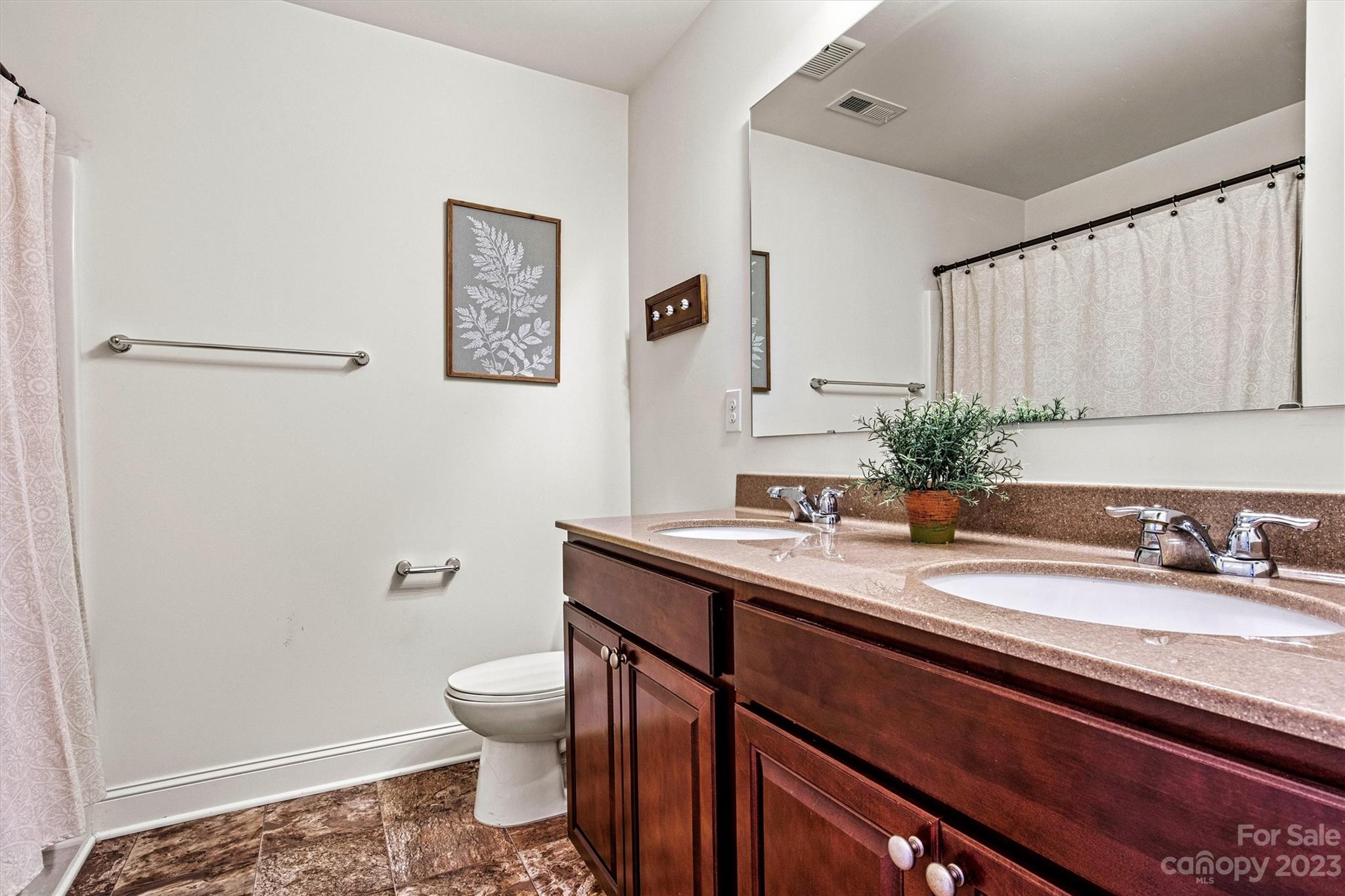 6054 Durango Way Denver, NC 28037 - Photo 28 of 38 a bathroom with a granite countertop sink a toilet and a mirror