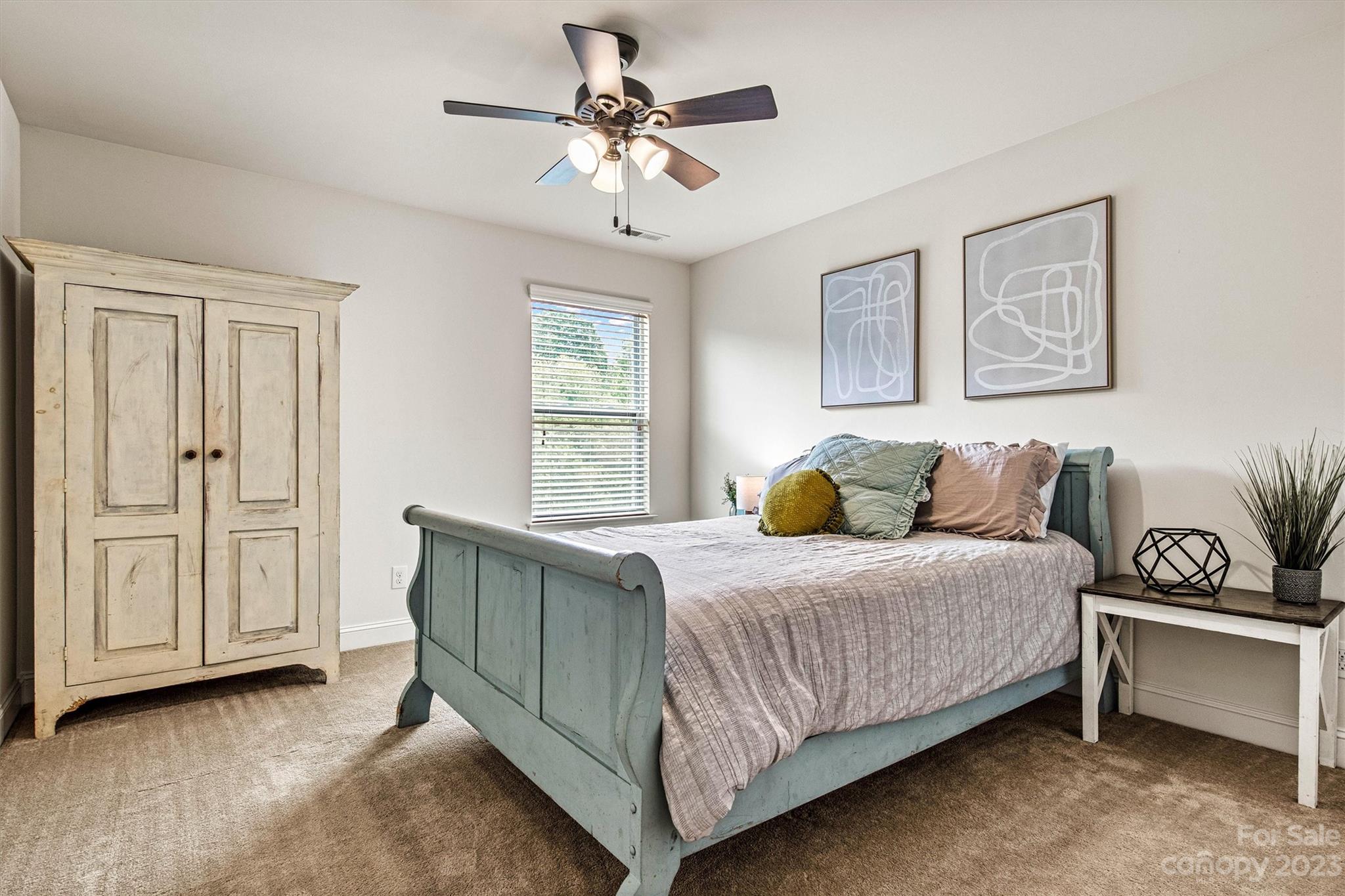 6054 Durango Way Denver, NC 28037 - Photo 29 of 38 a bedroom with a bed and a chandelier