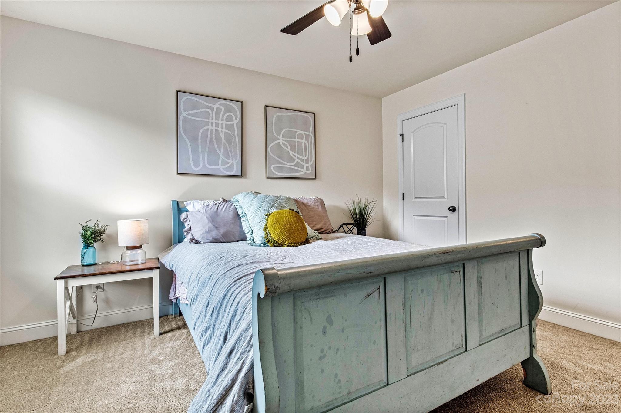 6054 Durango Way Denver, NC 28037 - Photo 30 of 38 a bedroom with a bed and a chandelier