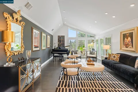 a living room with furniture and floor to ceiling windows