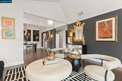 a view of a dining room with furniture and chandelier
