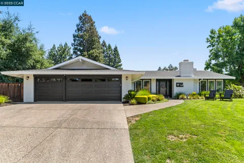 a front view of a house with yard and porch