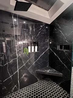 a view of a swimming pool with a table and chairs under an umbrella