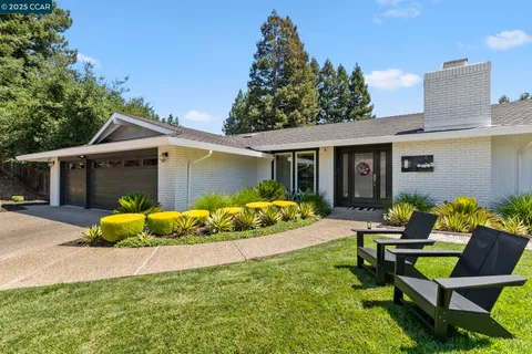 a front view of house with yard and outdoor seating