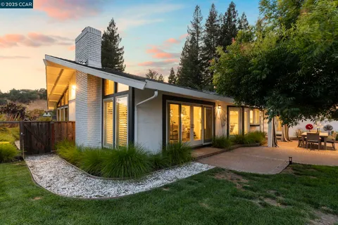 an aerial view of a house with a yard and a swimming pool