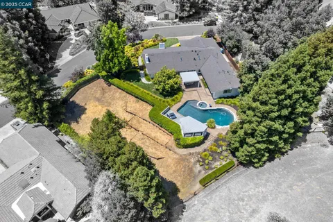 a view of a house with swimming pool and sitting area