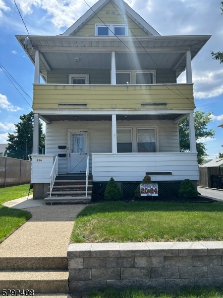 136 Carlton Avenue, Unit 1 East Rutherford, NJ 07073 - Photo 15 of 16 a front view of a house with a garden