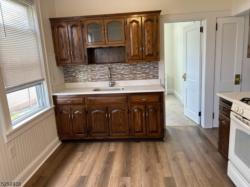 136 Carlton Avenue, Unit 1 East Rutherford, NJ 07073 - Photo 2 of 16 a kitchen with stainless steel appliances granite countertop a sink stove and refrigerator