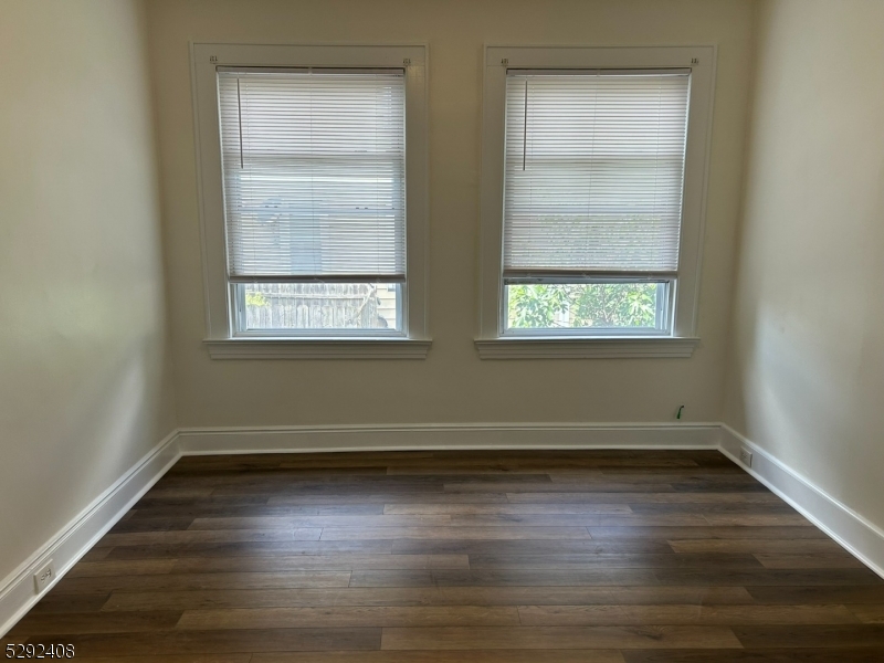 136 Carlton Avenue, Unit 1 East Rutherford, NJ 07073 - Photo 5 of 16 an empty room with wooden floor and windows