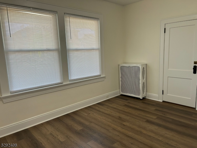 136 Carlton Avenue, Unit 1 East Rutherford, NJ 07073 - Photo 8 of 16 an empty room with wooden floor and windows